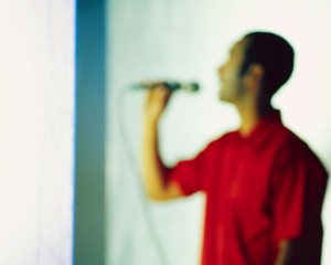 Man Singing into Microphone